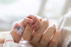 יד מחזיקה יד של תינוק